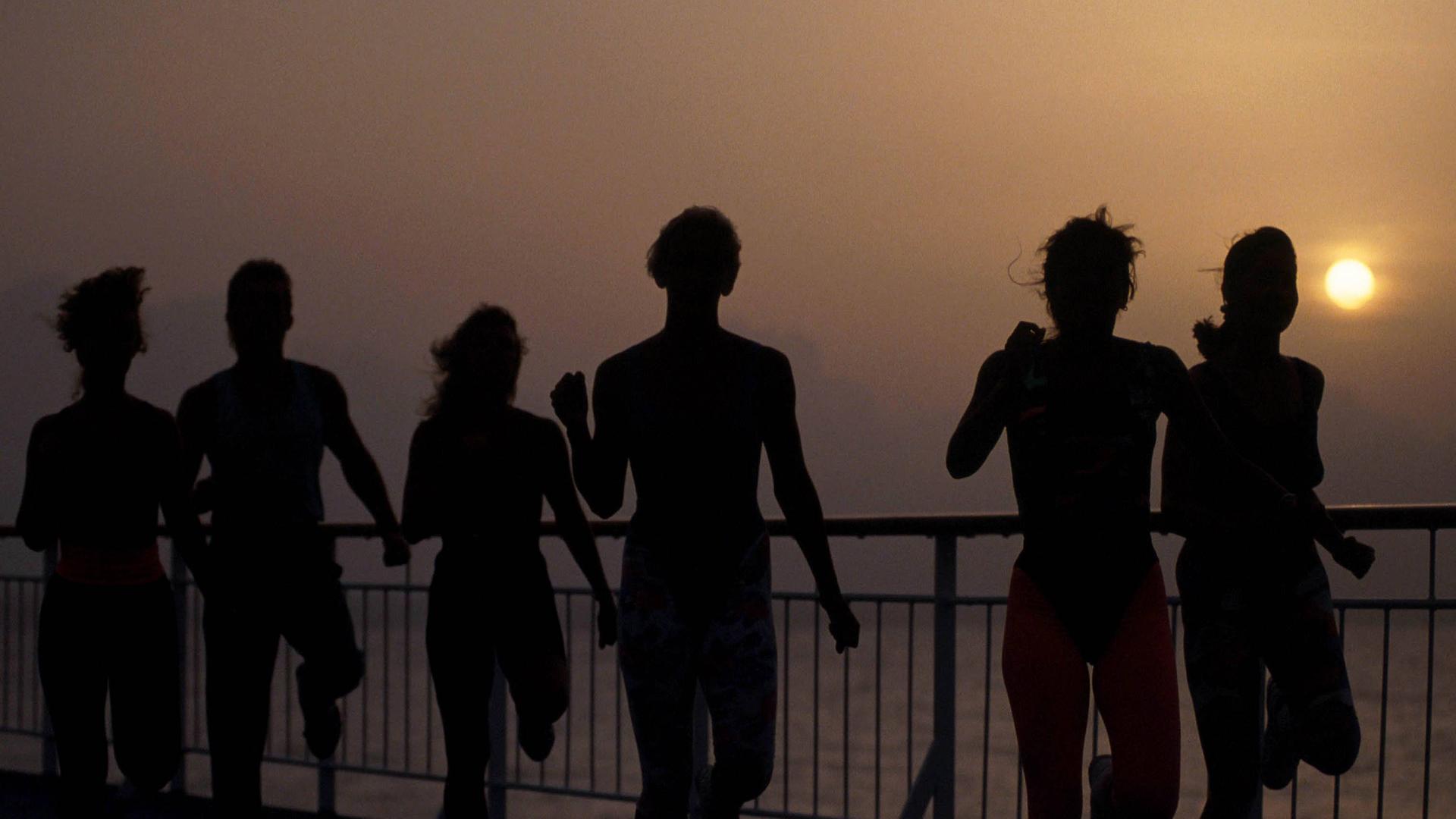 Eine Gruppe von Menschen in schnellem Lauf an einer Meerespromenade