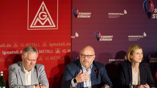 Daniel Friedrich (M), Verhandlungsführer IG Metall Küste, verkündet neben Horst Ott (l), Verhandlungsführer IG Metall Bayern, und Lena Ströbele (r), Verhandlungsführerin Nordmetall, auf einer Pressekonferenz die Einigung in den Tarifverhandlungen.