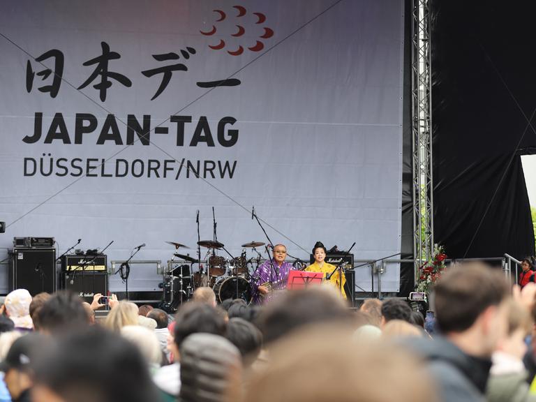 Düsseldorf: Zwei Musiker sitzen auf der Bühne in der Düsseldorfer Altstadt beim 22. Japan-Tag. 