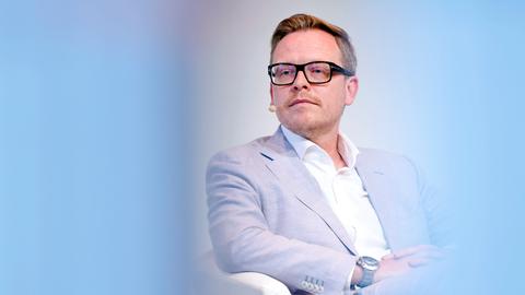 Porträt des Philosophen Markus Gabriel in einer Phil.Cologne Veranstaltung. Um ihn herum ist der Vordergrund hellblau verschwommen. Er trägt einen hellblauen Anzug und eine schwarze Brille. Porträt des Philosophen Markus Gabriel in einer Phil.Cologne Veranstaltung. Um ihn herum ist der Vordergrund hellblau verschwommen. Er trägt einen hellblauen Anzug und eine schwarze Brille.