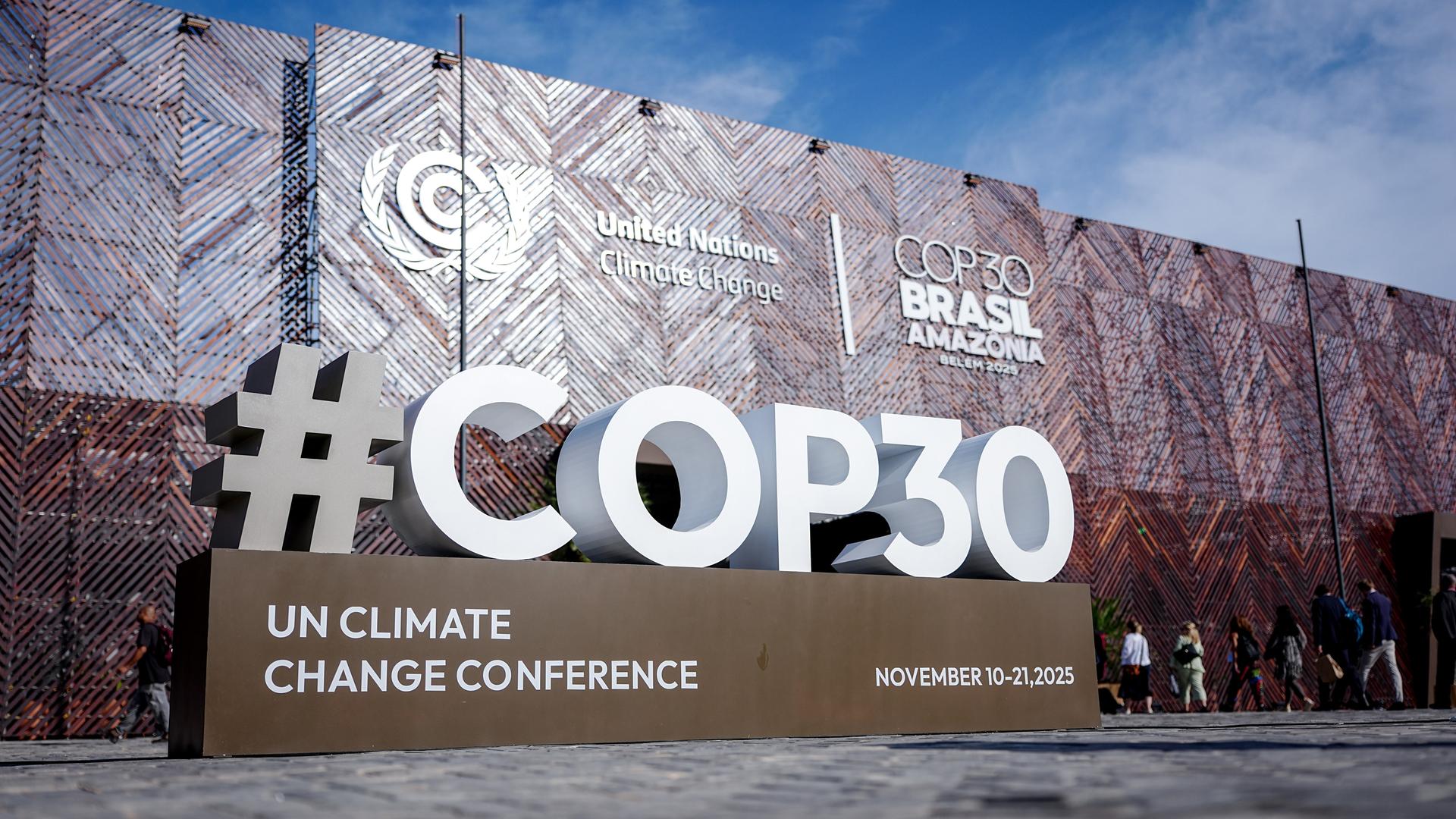 Vor dem Eingang zur Weltklimakonferenz ist das Logo "COP30" in großen weißen Lettern aufgestellt.