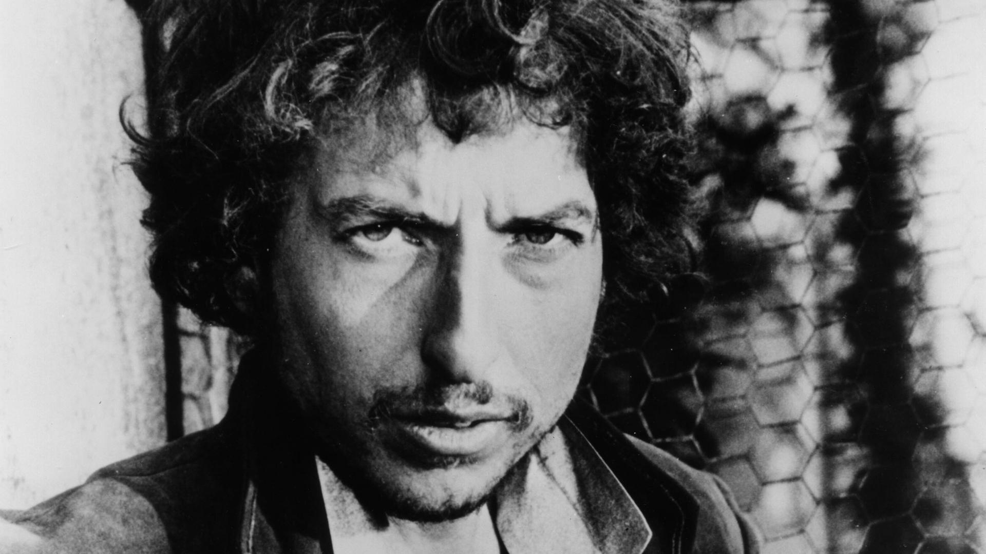 Schwarz-Weiß-Porträtfoto des US-Rocksängers Bob Dylan um 1975. Der Musiker schaut in die Kamera. Schwarz-Weiß-Porträtfoto des US-Rocksängers Bob Dylan um 1975. Der Musiker schaut in die Kamera.