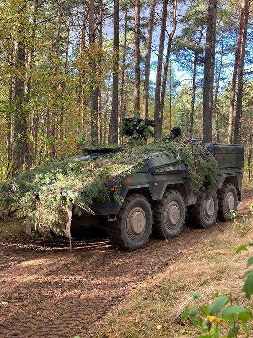 Ein Militärfahrzeug der Bundeswehr bei einer Übung im litauischen Waldgebiet. 
