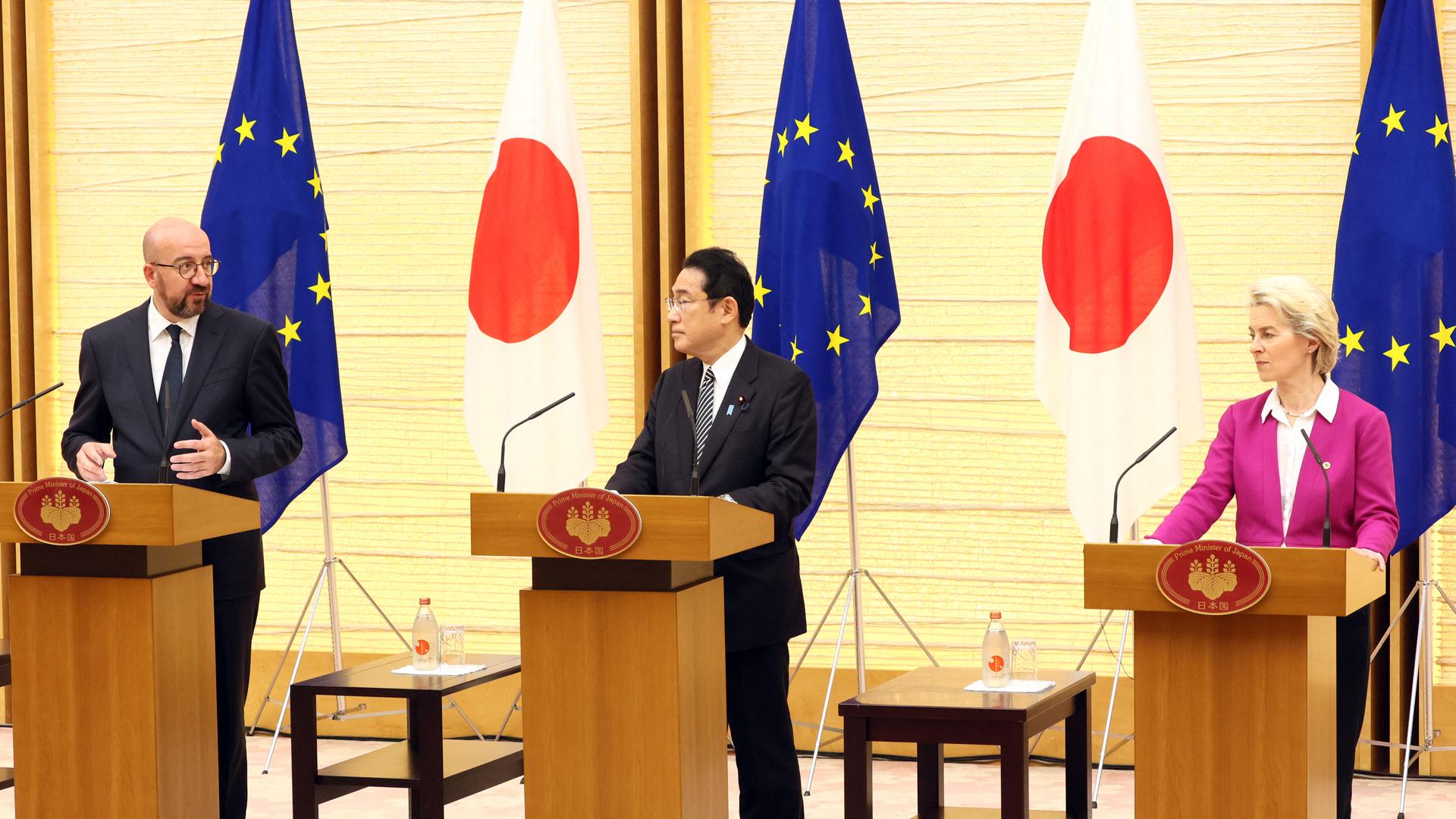 Das damalige EU-Ratspräsident Michel (li), Japans damaliger Regierungschef Kishida und EU-Kommissionspräsidentin von der Leyen stehen an Rednerpulten. Hinter ihnen sind die Flaggen der EU und Japans zu sehen. 