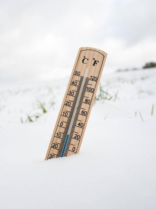 Wir sehen ein Thermometer, das im Schnee steckt. Wir sehen ein Thermometer, das im Schnee steckt.