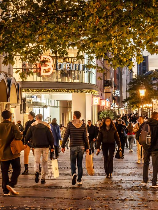 Menschen mit Taschen und Tüten abends in der Fußgängerzone Sendlinger Straße in München Menschen mit Taschen und Tüten abends in der Fußgängerzone Sendlinger Straße in München