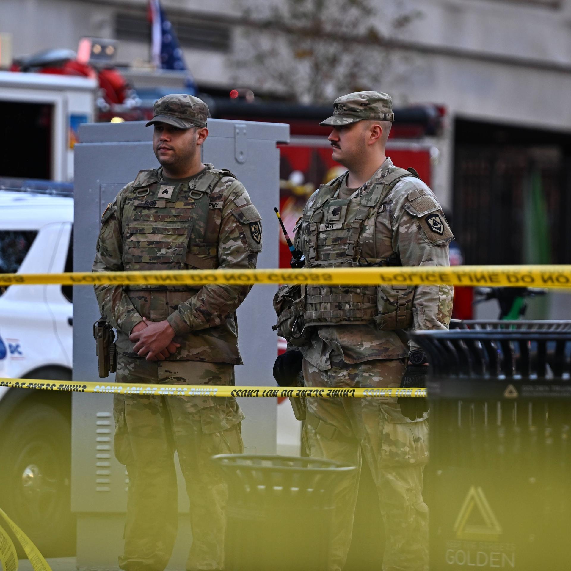 Zwei Nationalgardisten stehen hinter gelbem Flatterband.