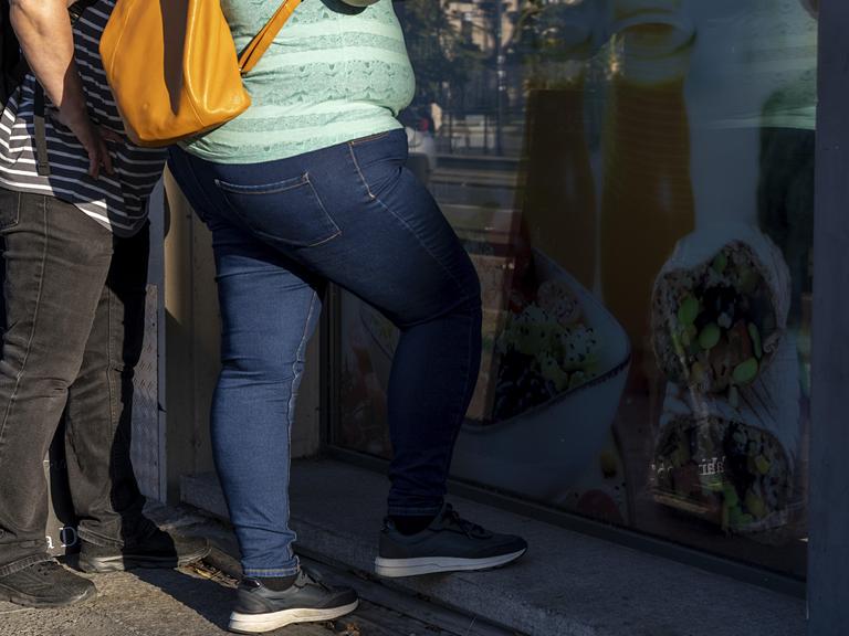 Personen mit Adipositas stehen an einer Eisdiele Personen mit Adipositas stehen an einer Eisdiele