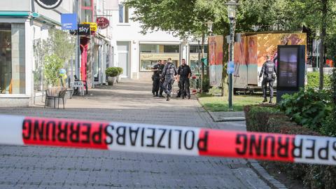 Einsatzkräfte stehen nach dem Messerangriff von Solingen in der Innenstadt hinter einer Polizeiabsperrung. 