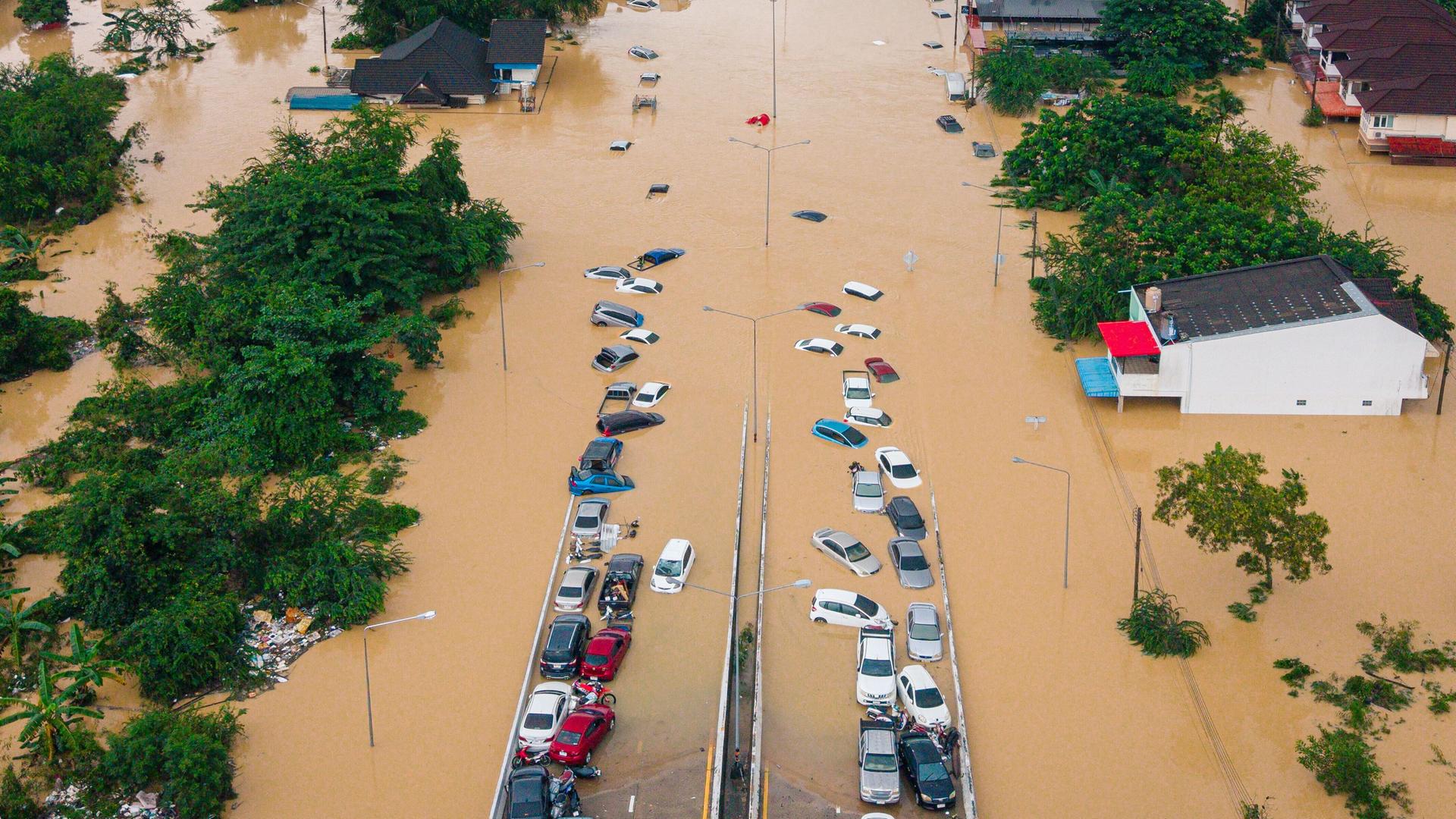 Thailand, Songkhla: Autos und Häuser stehen in der Provinz Songkhla im Süden Thailands unter Wasser.