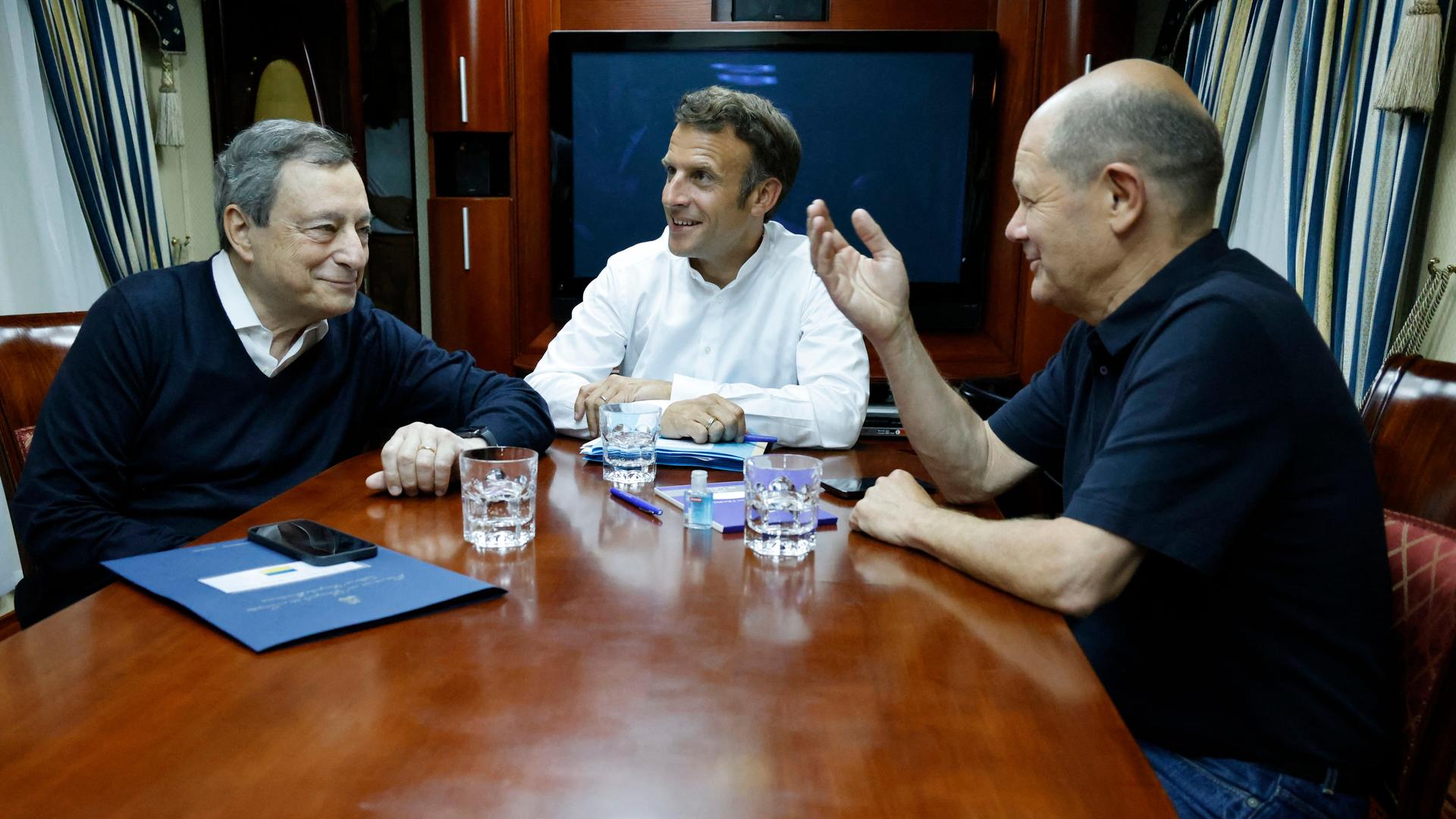 Der italienische Ministerpräsident Mario Draghi (l.), der französische Präsident Emmanuel Macron (M.) und Bundeskanzler Olaf Scholz sitzen in einem Zug nach Kiew. 