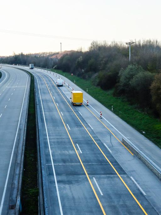 Blick auf eine leere Autobahn von oben, einzig ein DHL-Fahrzeug und zwei weitere Transporter sind zu sehen