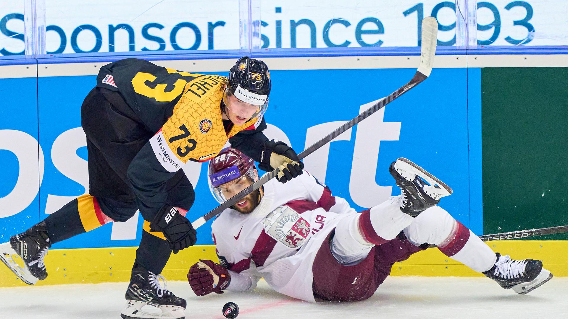 Der deutsche Eishockey-Nationalspieler Lukas Reichel setzt sicih im WM-Spiel gegen Lettland an der Bande durch.