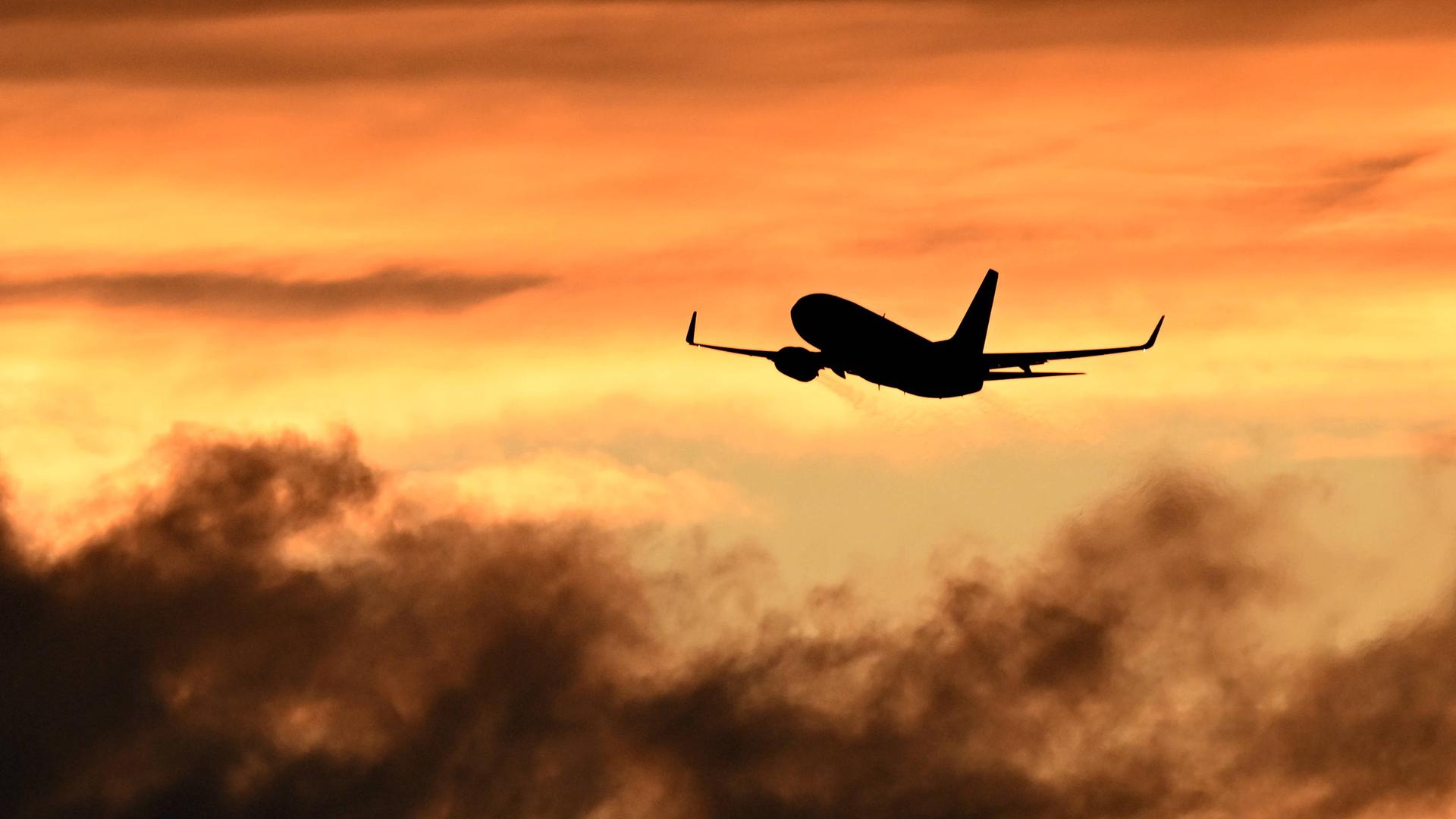 Ein Flugzeug beim Start vor Himmel bei Sonnenuntergang. Ein Flugzeug beim Start vor Himmel bei Sonnenuntergang.