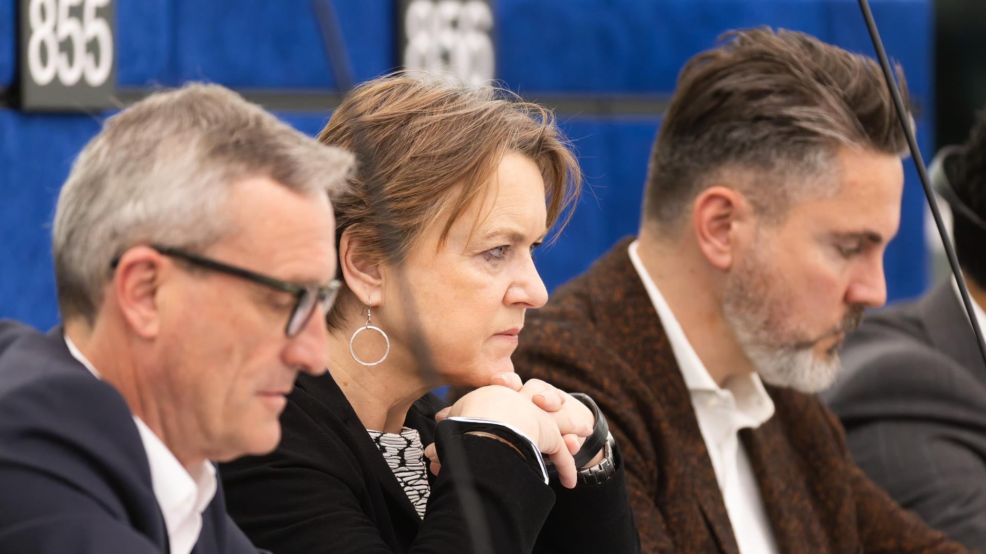 Ruth Firmenich (M, BSW) sitzt im Plenarsaal des Europäischen Parlaments und schaut ernst. 