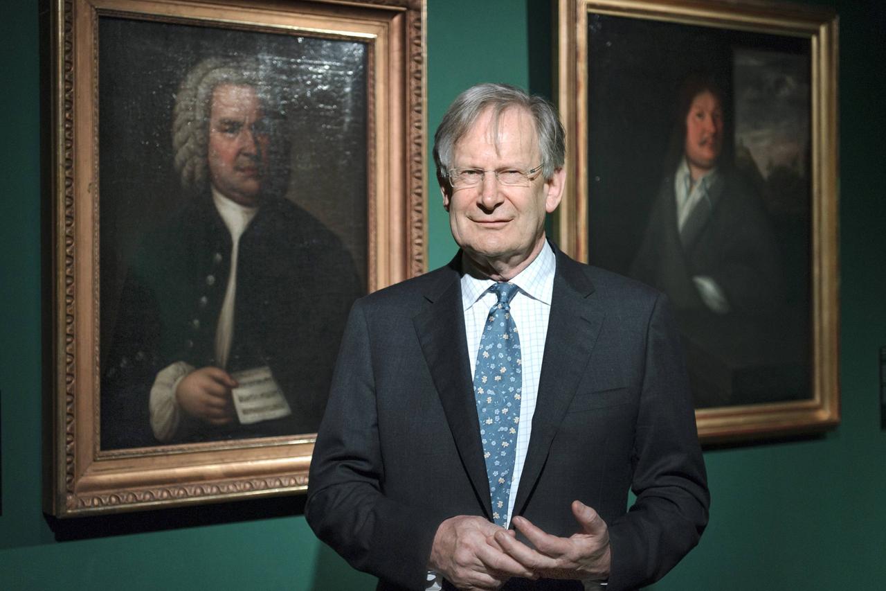 Sir John Eliot Gardiner steht 2014 im Bach-Museum zwischen dem Gemälde von Johann Sebastian Bach und seinem Vater Johann Ambrosius Bach.