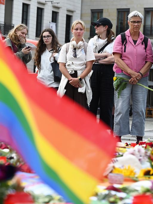 Mahnwache für die Opfer des mutmaßlichen Anschlags beim CSD. Menschen legen Blumen und Kerzen nieder. Mahnwache für die Opfer des mutmaßlichen Anschlags beim CSD. Menschen legen Blumen und Kerzen nieder.