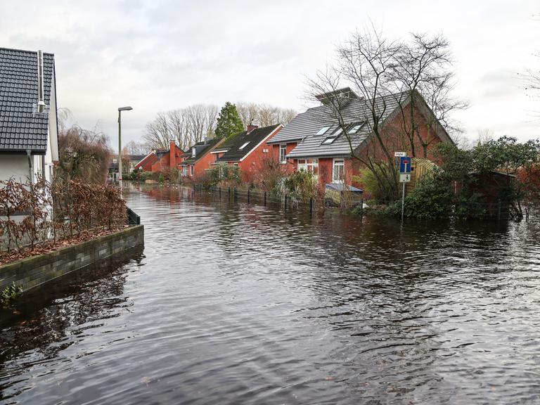 Wohnhäuser stehen in einem überfluteten Ortsbereich an der Wörpe. Durch das Hochwasser des Flusses sowie der nahegelegenen Wümme gab es in der Nacht einen Deichriss.