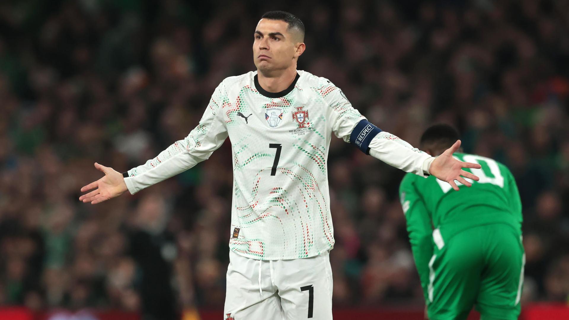 Ronaldo hebt unschuldig die Hände in die Höhe. Hinter ihm in Rückenansicht ein irischer Spieler.