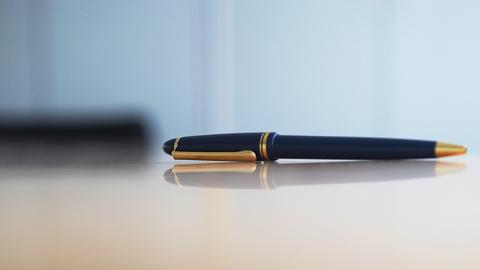Symbolbild zum Thema Schreiben: Ein Kugelschreiber liegt auf einem Konferenztisch. Symbolbild zum Thema Schreiben: Ein Kugelschreiber liegt auf einem Konferenztisch.