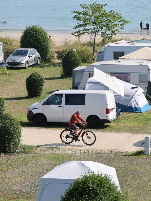 Städtischer Campingplatz mit Zelten und Wohnmobilen am Ende der Bucht von Locquirec in der Bretagne direkt am Strand. 