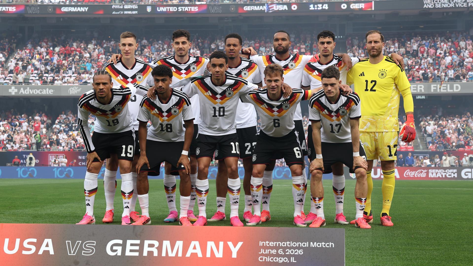 Mannschaftfoto des Teams: Die Spieler stehen in zwei Reihen vor einer vollbesetzten Trinübe auf dem Rasen. Mannschaftfoto des Teams: Die Spieler stehen in zwei Reihen vor einer vollbesetzten Trinübe auf dem Rasen.