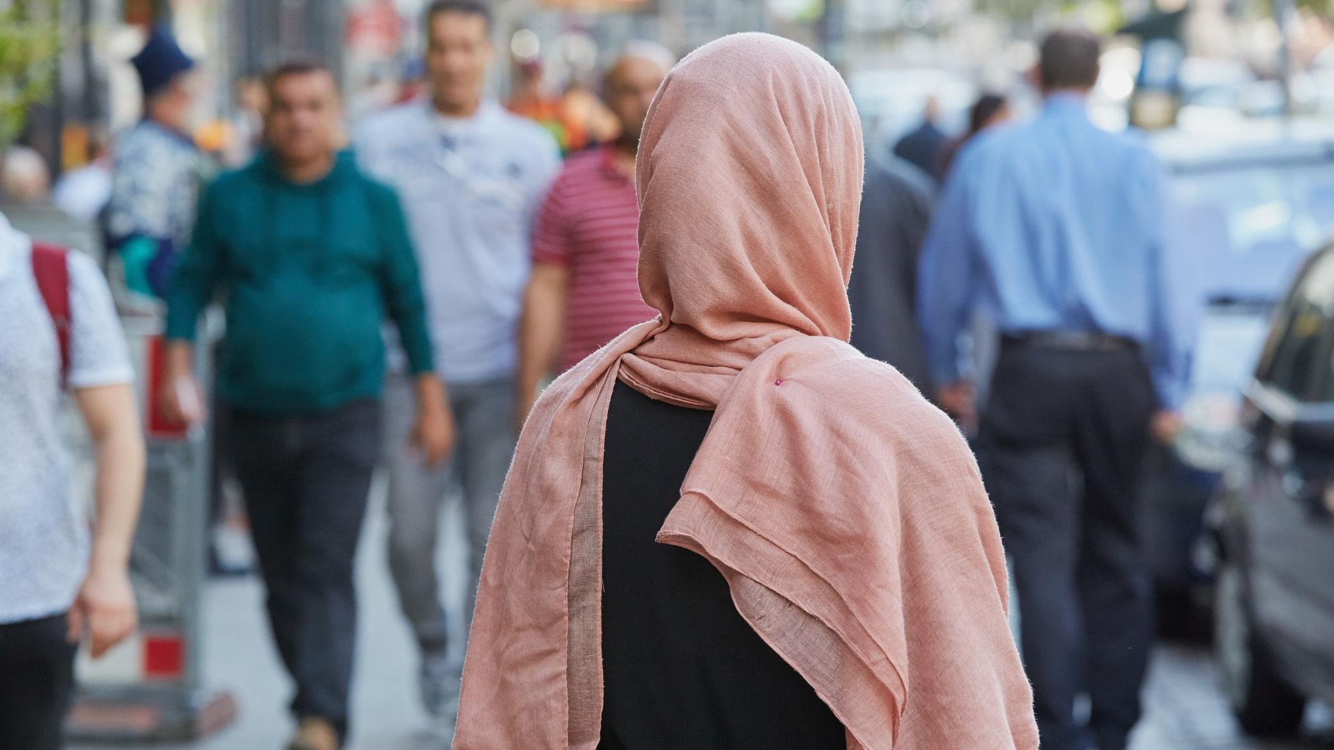 Hamburg: Eine deutsche Konvertitin mit Kopftuch, die Opfer eines tätlichen Übergriffes wurde, steht im Stadtteil St. Georg auf dem Bürgersteig. 898 antimuslimische Vorfälle hat die Allianz gegen Islam- und Muslimfeindlichkeit im vergangenen Jahr erfasst.