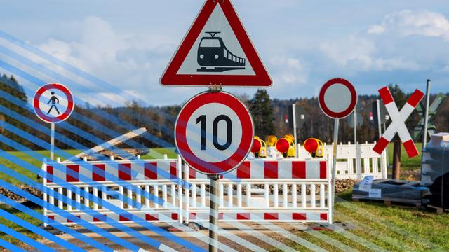 An einem Bahnübergang sind ein Bauzaun sowie diverse Verbotsschilder aufgestellt. An einem Bahnübergang sind ein Bauzaun sowie diverse Verbotsschilder aufgestellt.