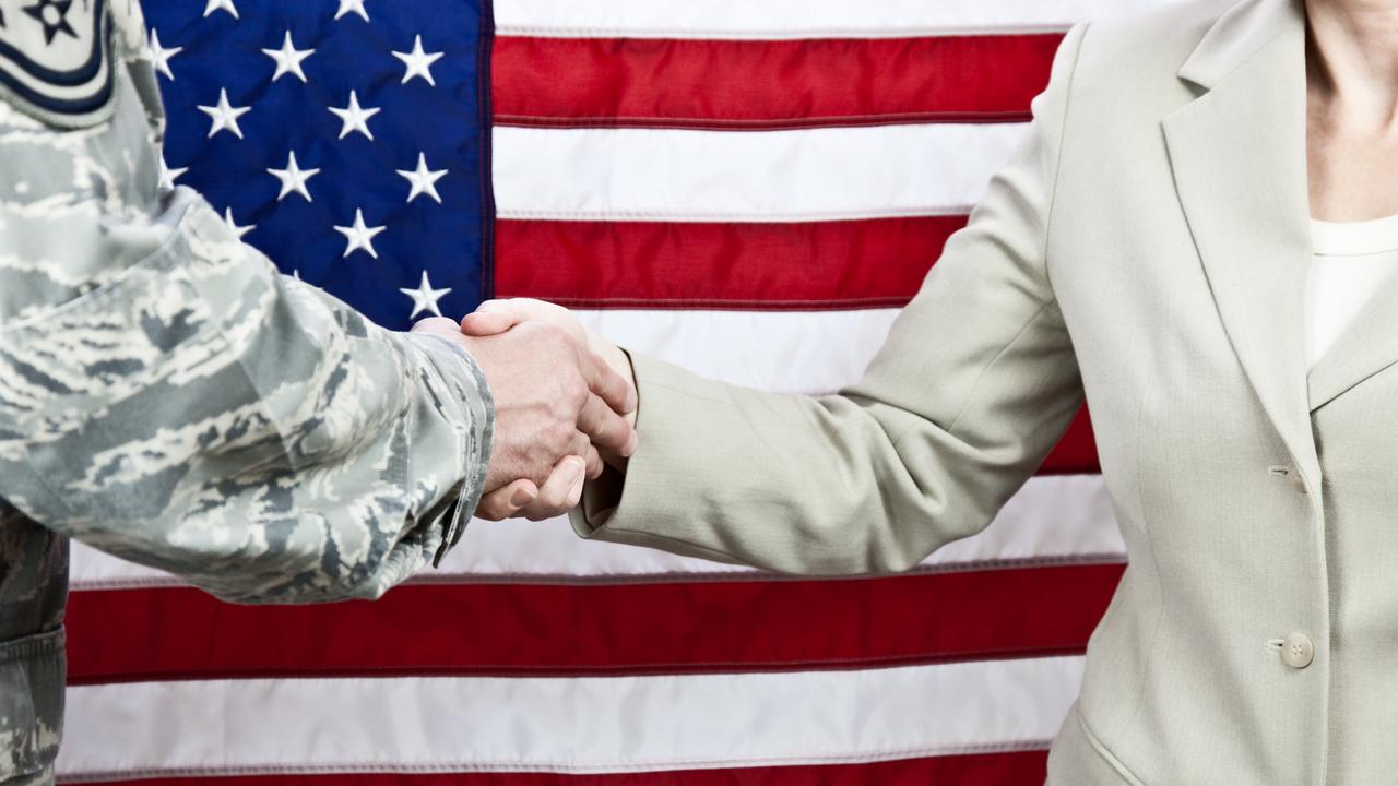 Handschlag zwischen einem Soldaten und einer Zivilistin. Aufnahme vor einer amerikanischen Flagge. Selektiver Fokus auf die Hände.
Handschlag zwischen einem Soldaten und einer Zivilistin. Aufnahme vor einer amerikanischen Flagge. Selektiver Fokus auf die Hände.