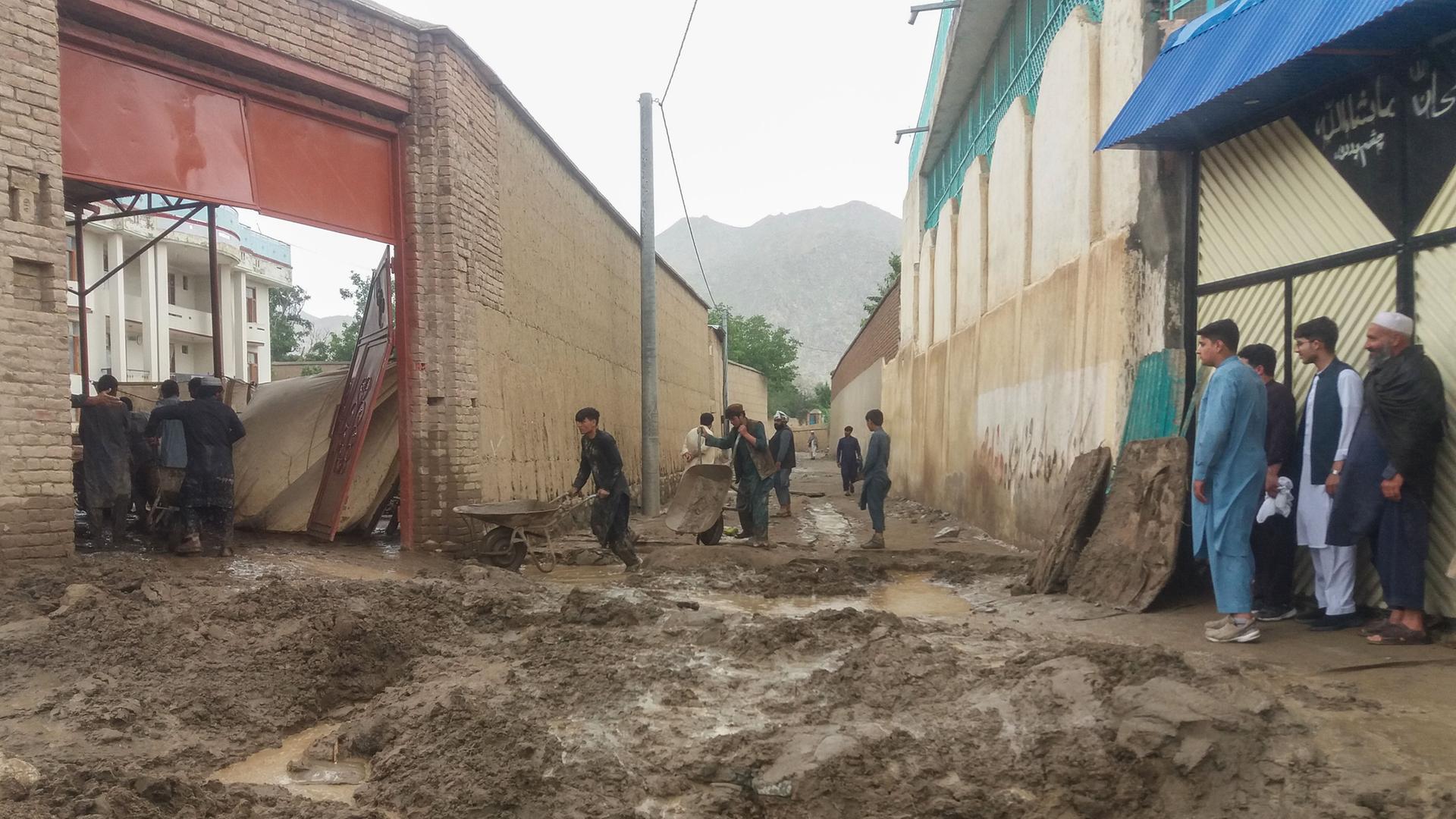 Das vom afghanischen Katastrophenschutz zur Verfügung gestellte Foto zeigt eine nach Sturzfluten mit Schlamm überspülte Straße. Das vom afghanischen Katastrophenschutz zur Verfügung gestellte Foto zeigt eine nach Sturzfluten mit Schlamm überspülte Straße.
