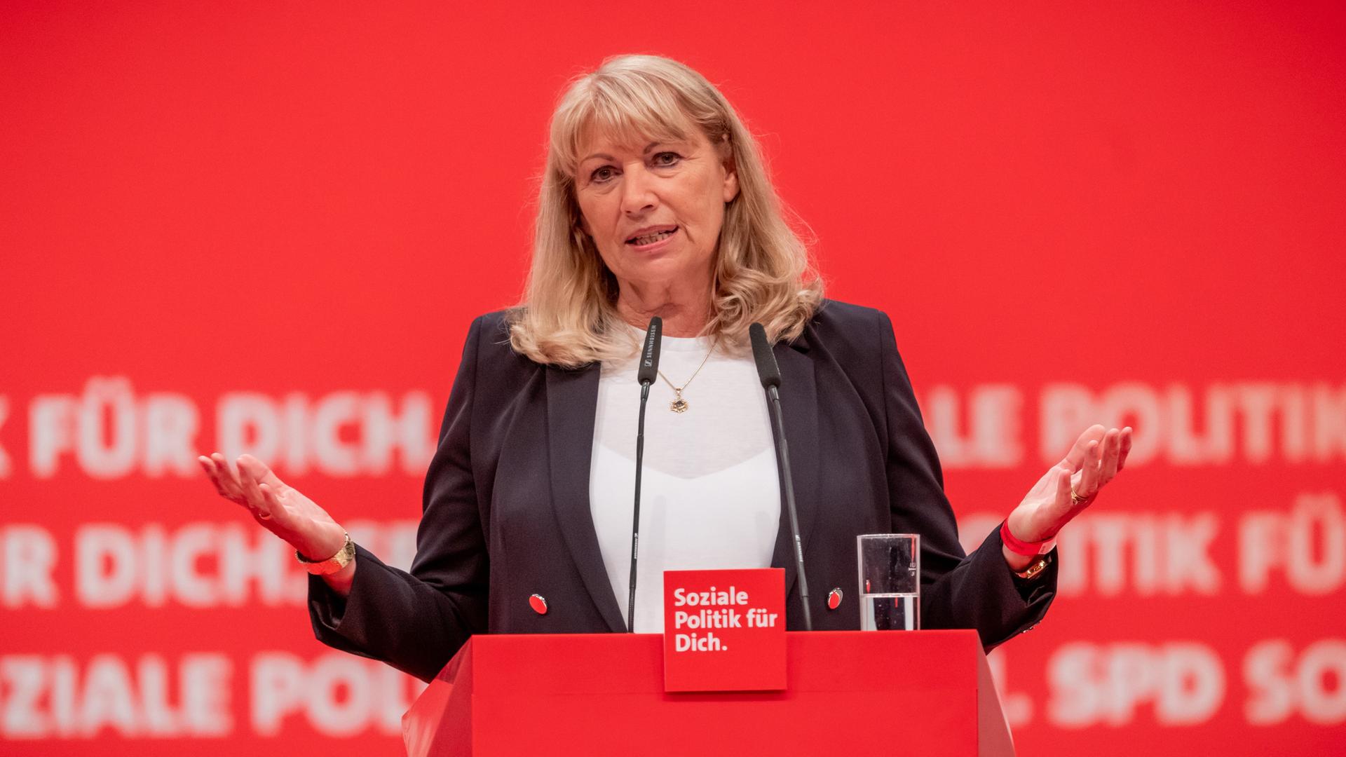 Petra Köpping spricht an einem roten Pult mit der Aufschrift "SPD - Soziale Politik für Dich". Dahinter eine rote Wand mit der gleichen Aufschrift SPD Petra Köpping spricht an einem roten Pult mit der Aufschrift "SPD - Soziale Politik für Dich". Dahinter eine rote Wand mit der gleichen Aufschrift SPD