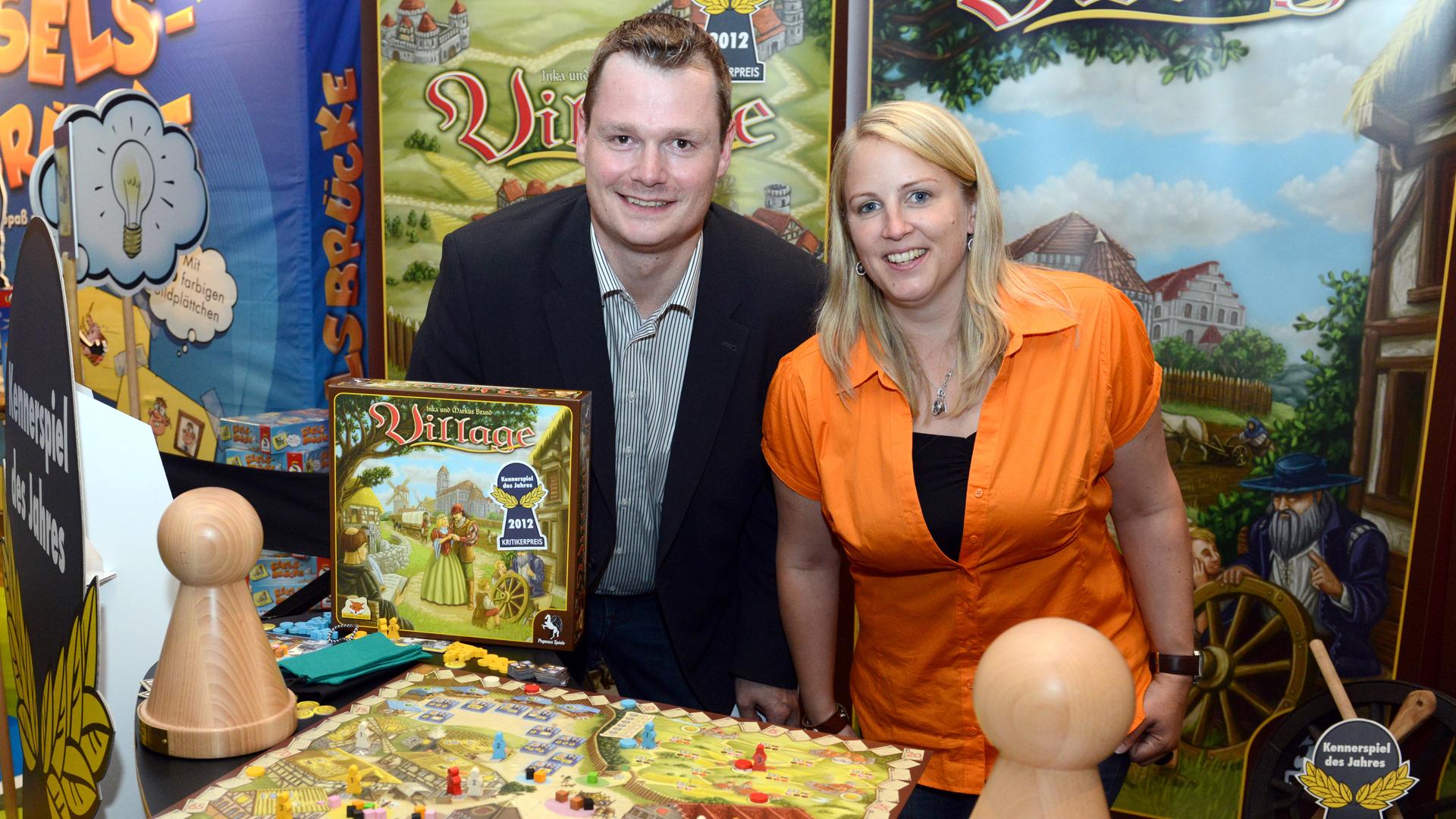 Die Autoren des Spiels "Village", das Ehepaar Inka und Markus Brand, stehen bei der Verleihung des Titels "Spiel des Jahres 2012" in Berlin hinter ihrem Brettspiel. 