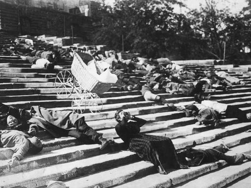 Schwarz-Weiß-Szene aus dem Stummfilm "Panzerkreuzer Potemkin": Auf der Treppe von Odessa liegen zahlreiche niedergeschossene Menschen, zwischen ihnen rollt ein unbeaufsichtiger Kinderwagen die Treppe herunter Schwarz-Weiß-Szene aus dem Stummfilm "Panzerkreuzer Potemkin": Auf der Treppe von Odessa liegen zahlreiche niedergeschossene Menschen, zwischen ihnen rollt ein unbeaufsichtiger Kinderwagen die Treppe herunter