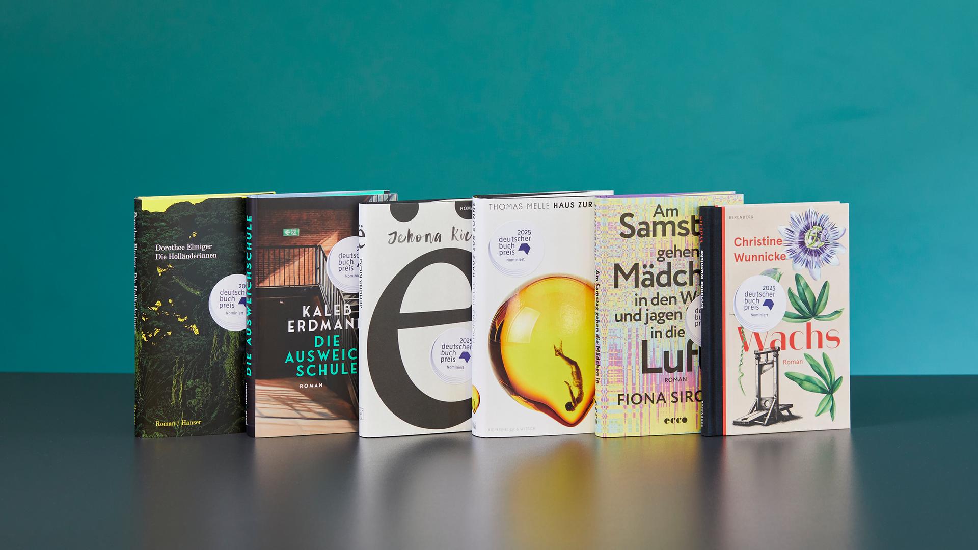 Die Bücher der Shortlist für den Buchpreis 2025 stehen nebeneinander.