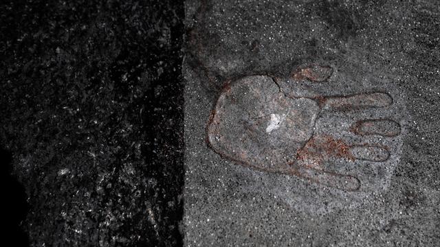 Hinterlassener Handabdruck einer mit Sekundenkleber festgeklebten Hand von einem Klimademonstranten der Letzten Generation auf dem Asphalt einer Strasse in Berlin Mitte Deutschland.