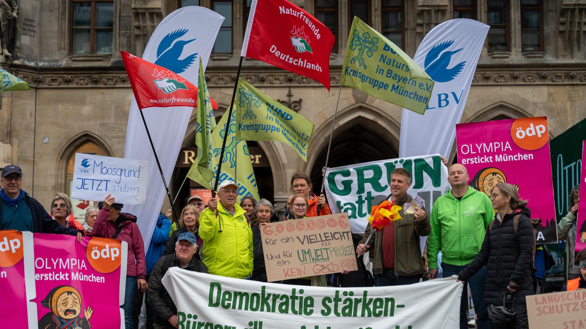 Mehrere Menschen nehmen an einer Demonstration auf dem Marienplatz gegen die geplante Olympia-Bewerbung Münchens teil. Mehrere Menschen nehmen an einer Demonstration auf dem Marienplatz gegen die geplante Olympia-Bewerbung Münchens teil.