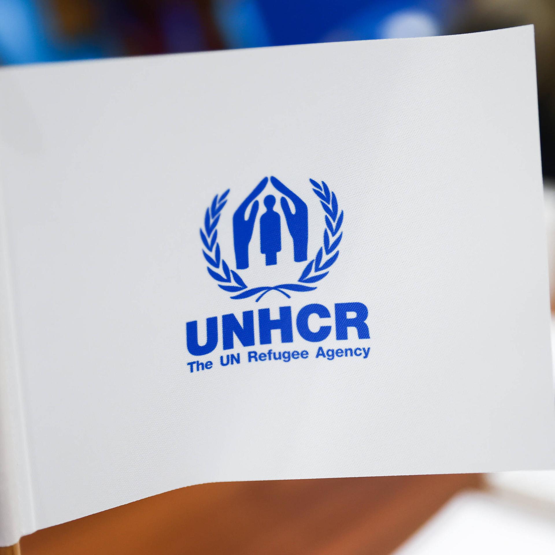 Das Logo des UNHCR ist auf einem Wimpel zu sehen.
