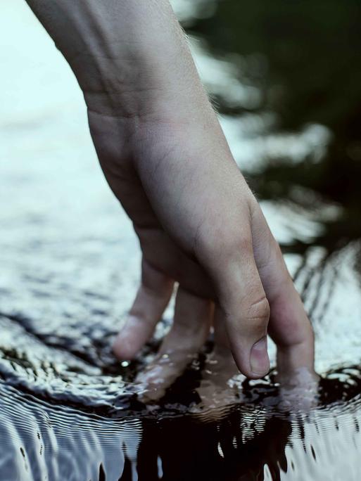 Eine Hand im Wasser.