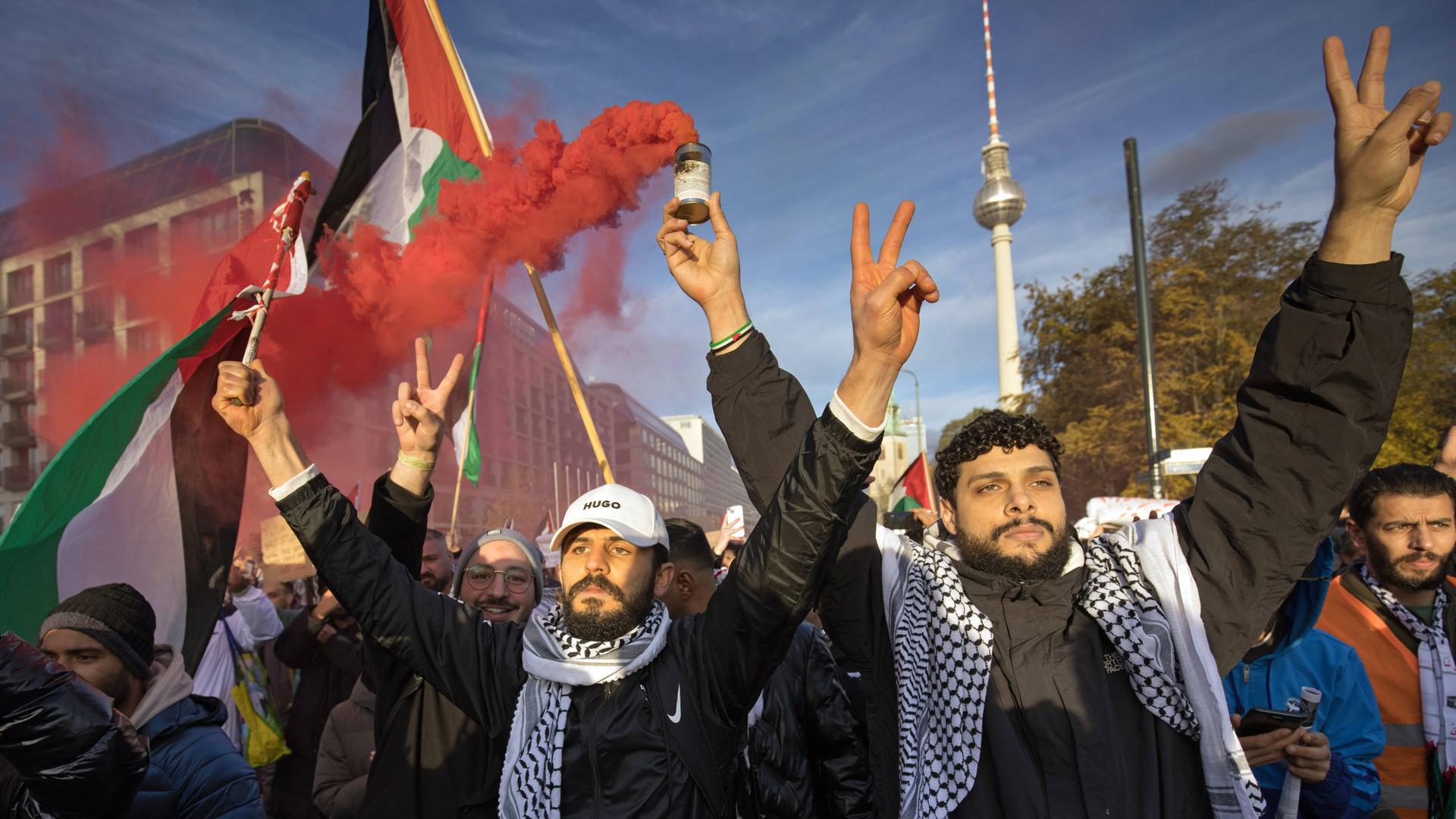 Männer auf einer pro-palästinensischen Kundgebung in Berlin. Es werden Palästina-Flaggen geschwenkt.