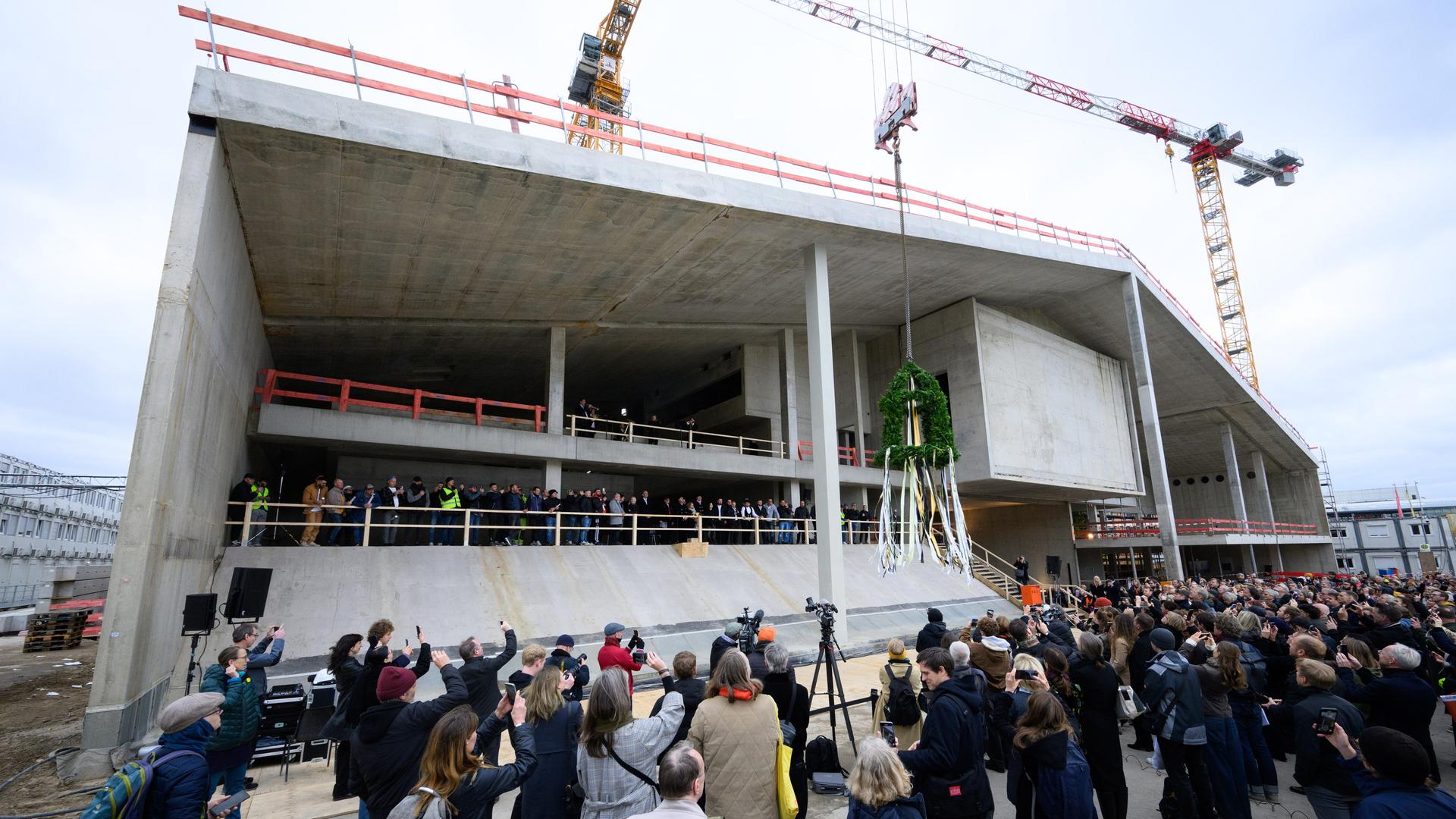 Der Richtkranz beim Richtfest für den Neubau des Museums Berlin Modern am Kulturforum in Berlin-Tiergarten von einem Kran hochgezogen. Der Richtkranz beim Richtfest für den Neubau des Museums Berlin Modern am Kulturforum in Berlin-Tiergarten von einem Kran hochgezogen.