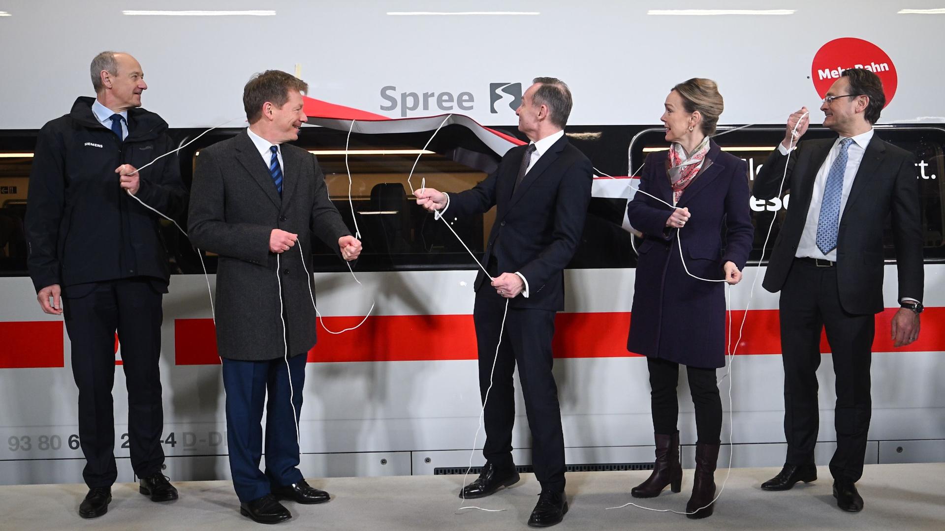 Berlin: Roland Busch (l-r), Vorsitzender des Vorstands der Siemens AG, Richard Lutz, Vorsitzender des Vorstands der Deutschen Bahn AG, Volker Wissing (FDP), Bundesminister für Verkehr und Digitales, Manja Schreiner (CDU), Berliner Senatorin für Mobilität, Verkehr, Klimaschutz und Umwelt, und Michael Peterson, DB-Vorstand Personenfernverkehr, enthüllen während der Taufe und Übergabe des letzten ICE Berlin: Roland Busch (l-r), Vorsitzender des Vorstands der Siemens AG, Richard Lutz, Vorsitzender des Vorstands der Deutschen Bahn AG, Volker Wissing (FDP), Bundesminister für Verkehr und Digitales, Manja Schreiner (CDU), Berliner Senatorin für Mobilität, Verkehr, Klimaschutz und Umwelt, und Michael Peterson, DB-Vorstand Personenfernverkehr, enthüllen während der Taufe und Übergabe des letzten ICE