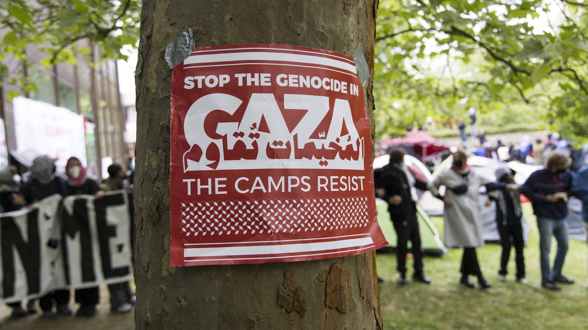 Ein Poster mit der Aufschrift "Stop the Genocide in Gaza - The Camps Resist" an der FU Berlin.