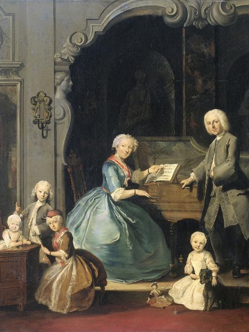Auf einem Gemälde aus der Barockzeit, das Cornelis Troost zugeschrieben wird (1739) sitzt ein Frau mit heller Haube am Cembalo, während sie von ihrer Familie umringt ist.