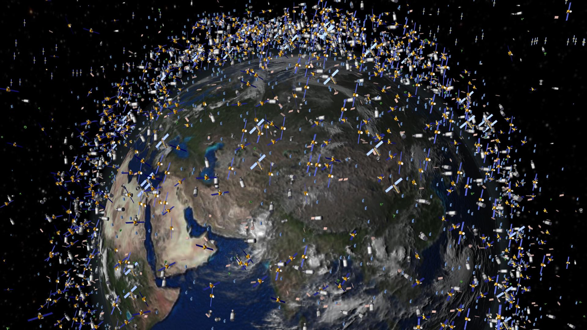 Das undatierte Handout der ESA zeigt eine Computersimulation von Weltraummüll früherer Weltraummissionen, der neben intakten Satelliten um die Erde kreist.