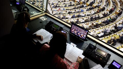 Blick aus der Dolmetscherbox auf das kreisförmig angeordnete Plenum im Europäischen Parlament.