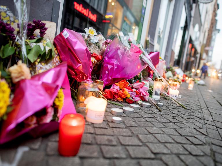 Zahlreiche Blumen und Kerzen stehen in der Oldenburger Innenstadt an einer Hauswand.