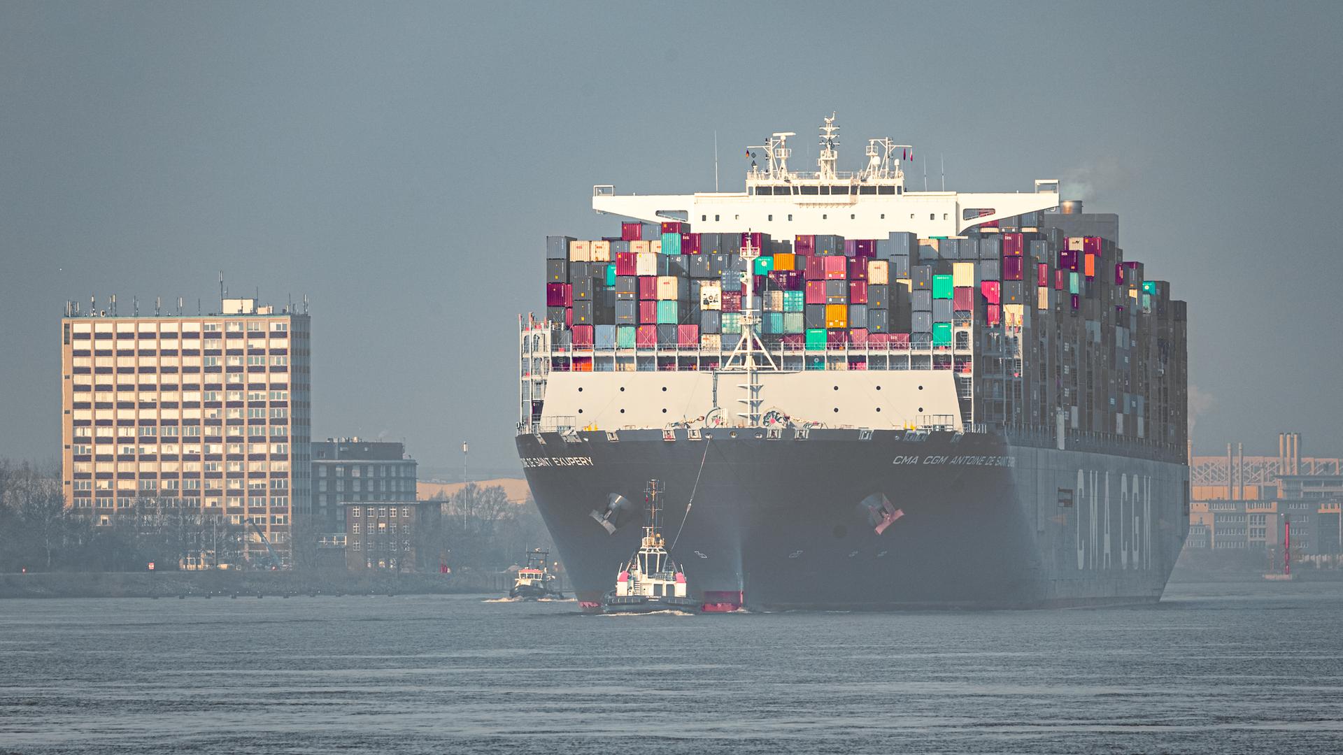 Das Conatinerschiff CMA CGM Antoine de Saint Exupery der französischen Reederei CMA CGM läuft bei leichtem Morgennebel in den Hamburger Hafen ein.