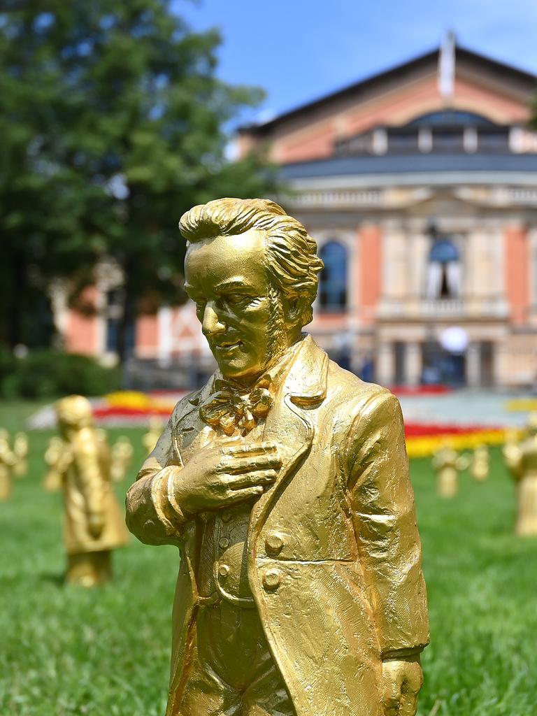 Goldene Skulpturen von Richard Wagner stehen bei den Wagnerfestspielen 2025 auf dem Grünen Hügel vor dem Festspielhaus.