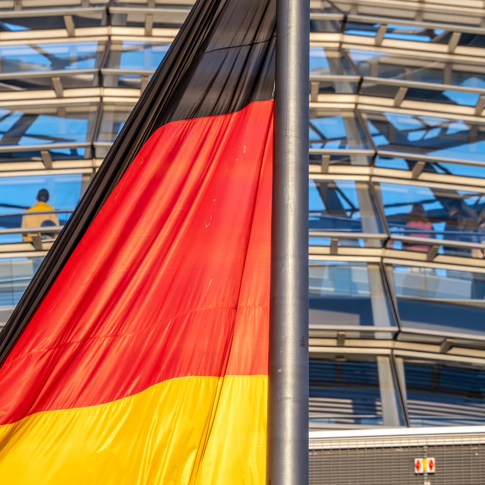  Deutschlandfahne im Abendlicht vor der Reichstagskuppel