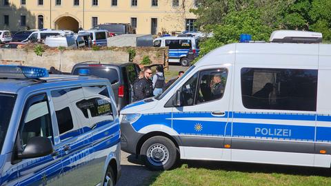 Sachsen, Halsbrücke: Polizeibeamte durchsuchen nach dem Verbot der Reichsbürger-Gruppe "Königreich Deutschland" Gebäude. Mehrere Polizeiwagen stehen auf den Straßen. 